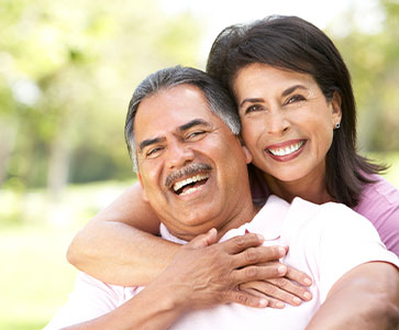 Photo of a man and woman smiling for a picture. Link to Life Stage Gift Planner Under Age 45 Situations.